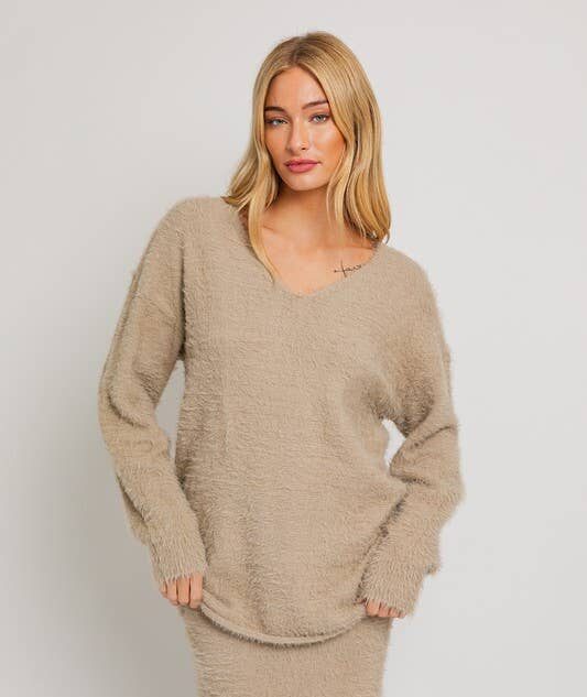 Woman in a beige fuzzy sweater.