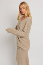 Beige fuzzy sweater and skirt set.