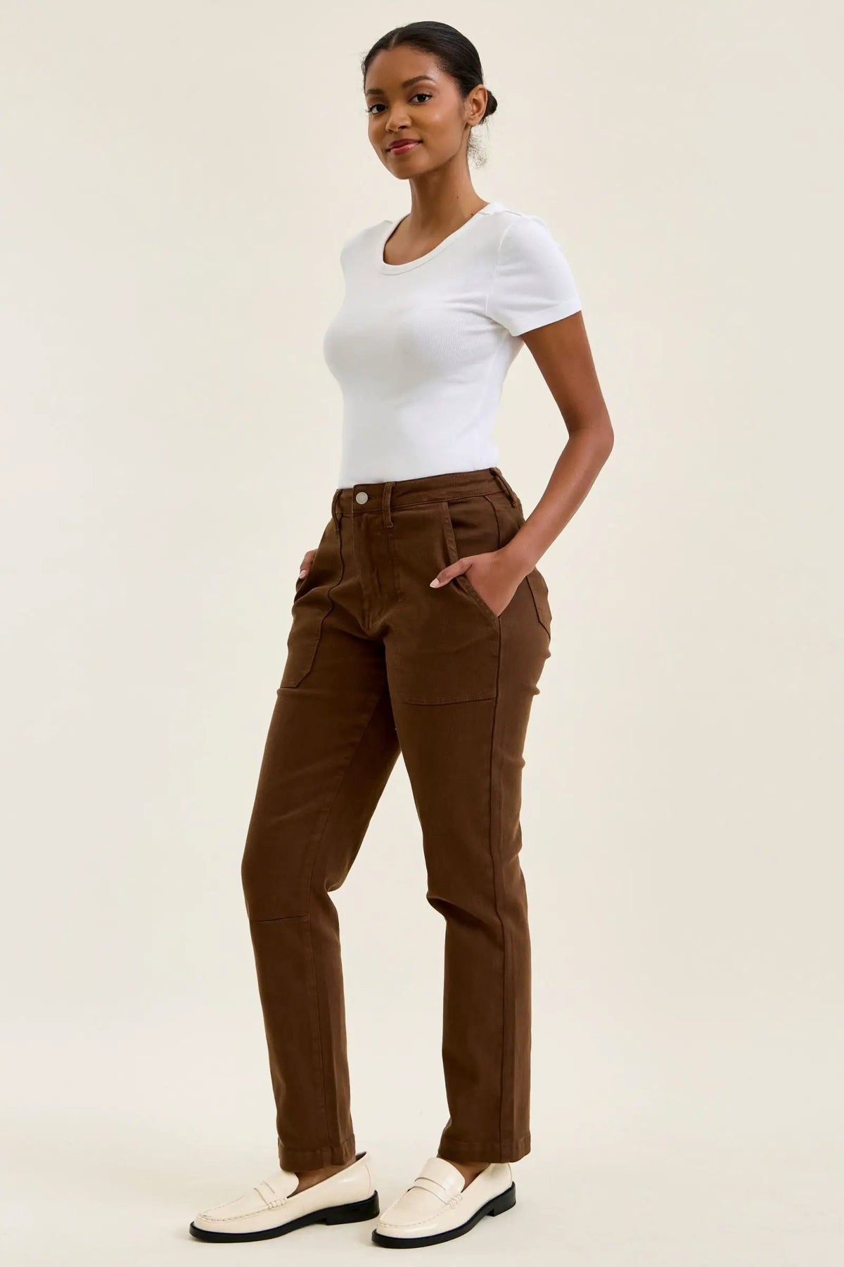 High-waist mahogany stretch jeans with slim straight leg, fitted top block, and double-rolled cuff for a tailored look.