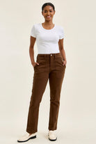 High-waist mahogany stretch jeans with slim straight leg, featuring a fitted top block, double-rolled cuff, and knee darts for a tailored shape.