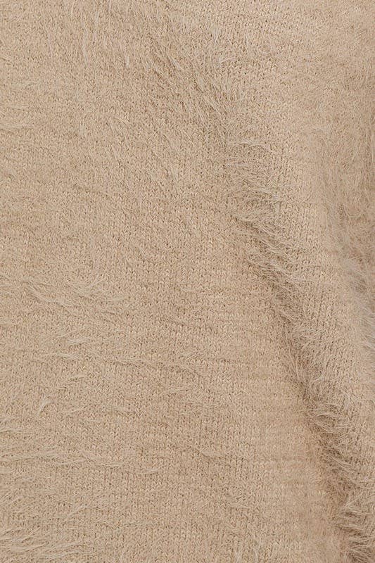 Beige fluffy knit fabric texture.