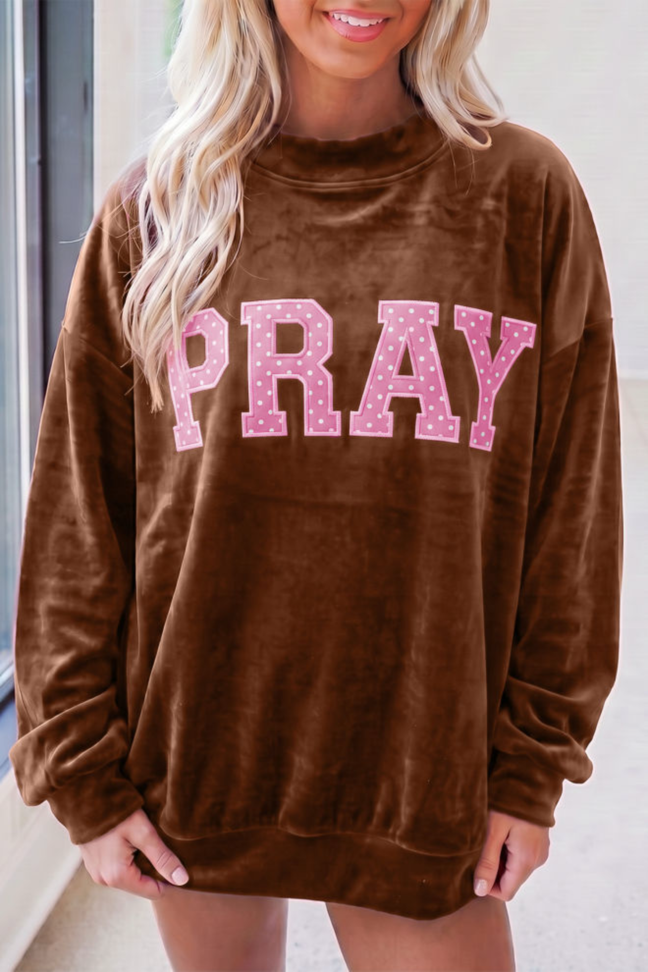 Brown velvet sweatshirt featuring PRAY in pink polka dot letters. Soft, coffee-colored Southern style top.