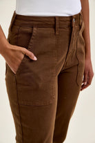 High-waist mahogany stretch jeans with slim straight leg, featuring a fitted top block and tailored knee darts for a polished shape.