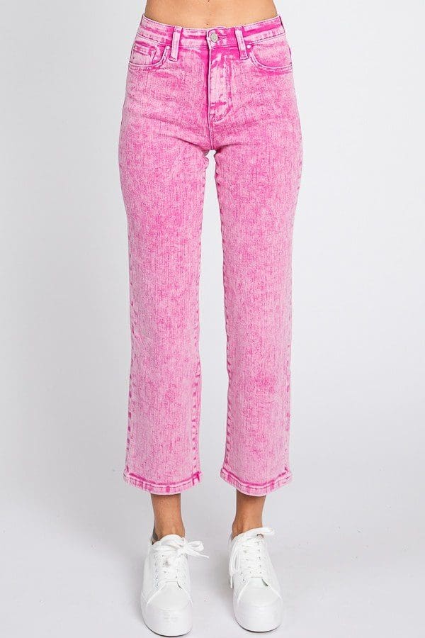 A woman wearing pink pants and white shoes.