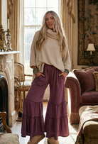 The Relaxed Luxury loungewear by Grateful Threads Boutique: cream cozy sweater and purple tiered pants.