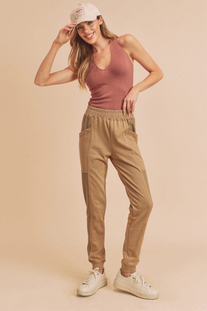 A woman in tan pants and a pink top