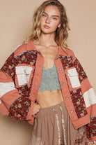 Woman in patchwork floral jacket.