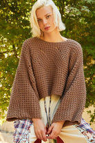 Brown knit cropped sweater with bell sleeves.