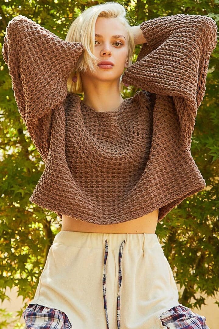 Brown knit sweater, model posing.