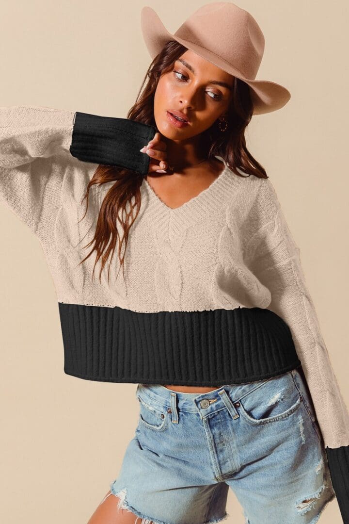 Beige and black cable knit sweater.