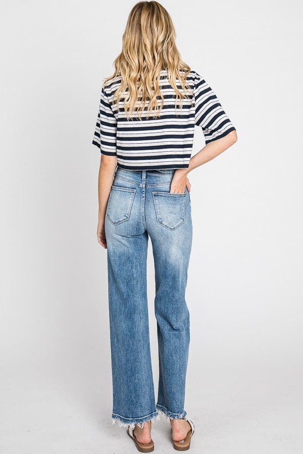 A woman wearing jeans and striped shirt.