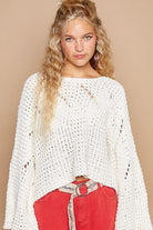 Woman in white open-knit sweater.