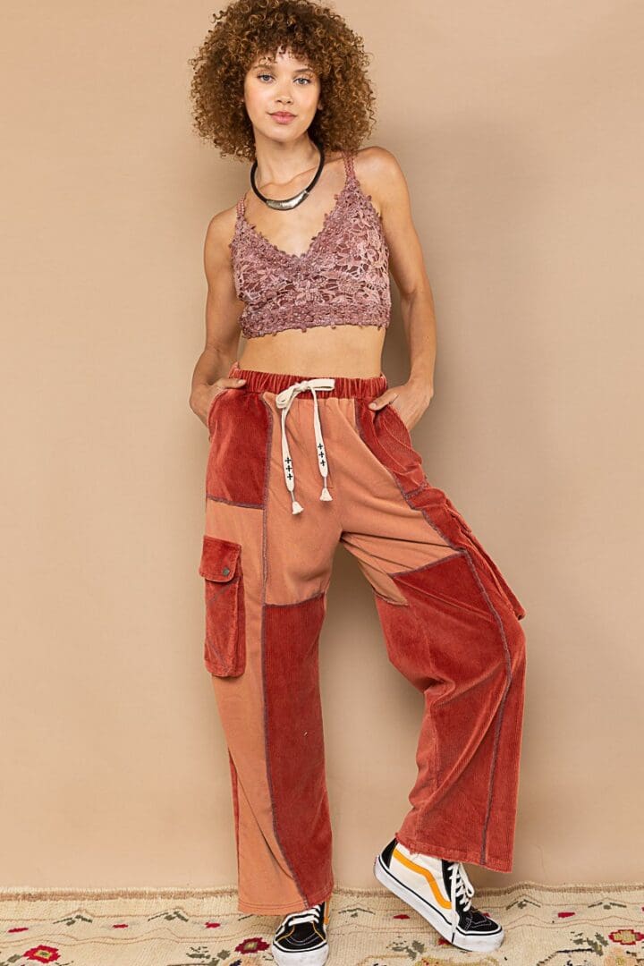 Model in patchwork corduroy pants and top.