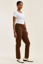 High-waist mahogany stretch jeans with a slim straight leg, fitted top block, and double-rolled cuff for a tailored silhouette.