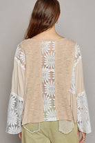 Beige top with white floral lace detail.