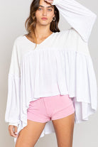 White peasant top with pink shorts.