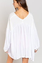 White tunic with balloon sleeves.