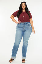 A woman standing in front of the camera wearing jeans.