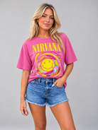 Pink Nirvana graphic tee featuring a rainbow smiley face design, embodying grunge rock style.