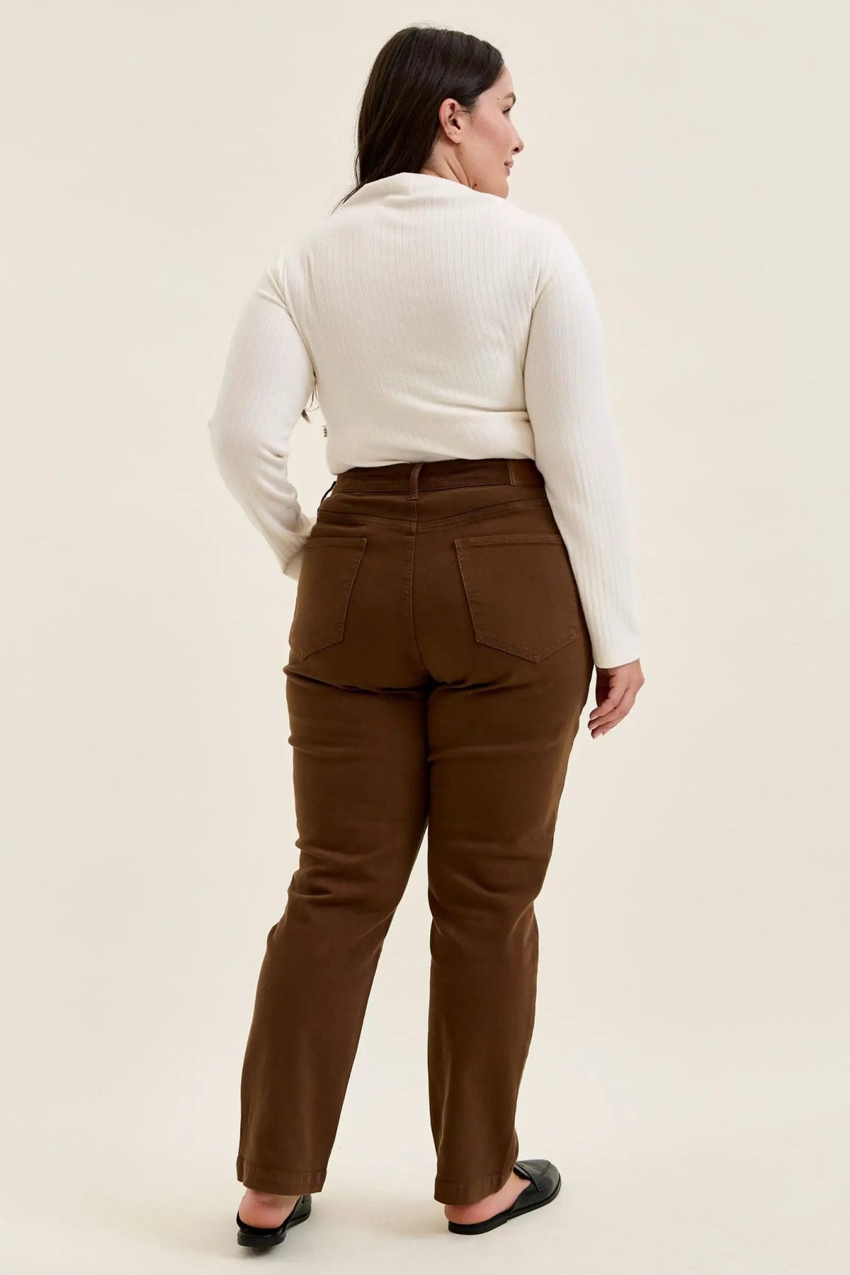 Back view of mahogany high-waist plus stretch jeans featuring classic utility pockets and a slim-straight leg fit.