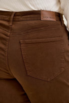 Mahogany high-waist jeans featuring a Judy Blue leather patch and classic utility back pocket stitching on plus stretch denim.