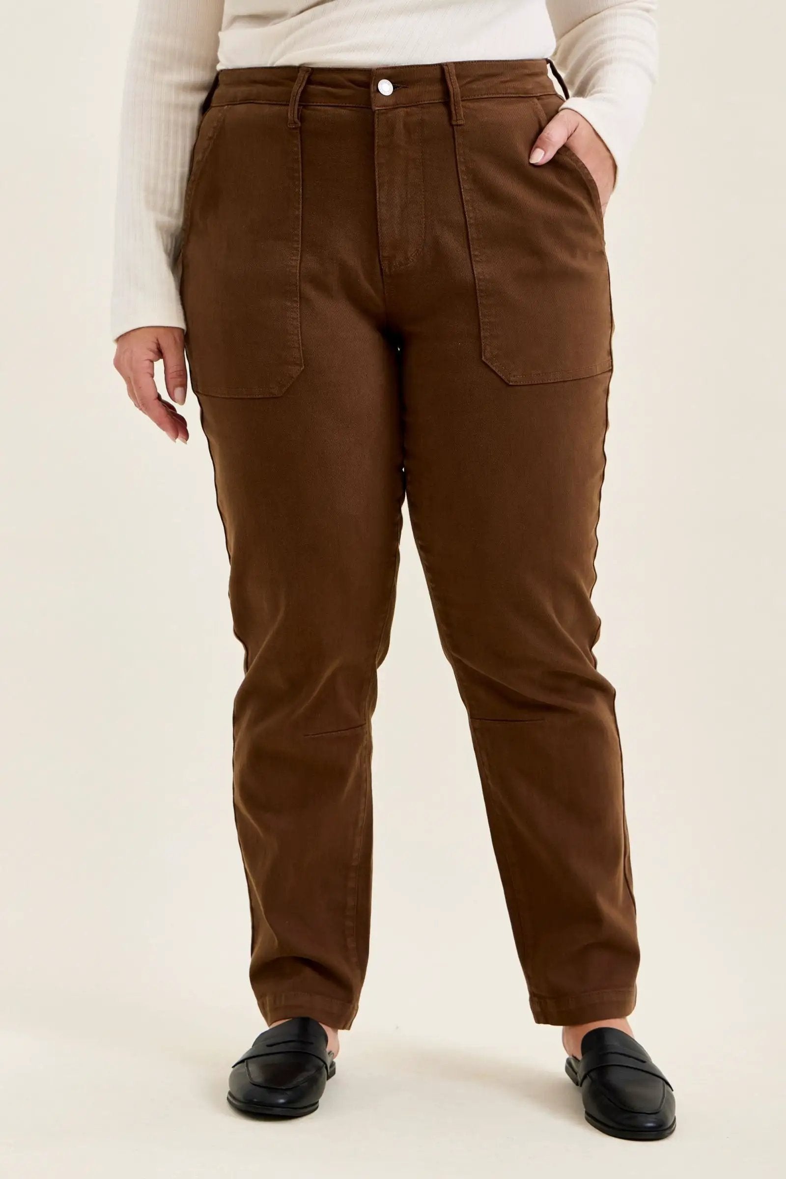 Mahogany high-waist plus size jeans featuring slim-straight legs, large utility pockets, and double-rolled cuffs paired with black loafers.