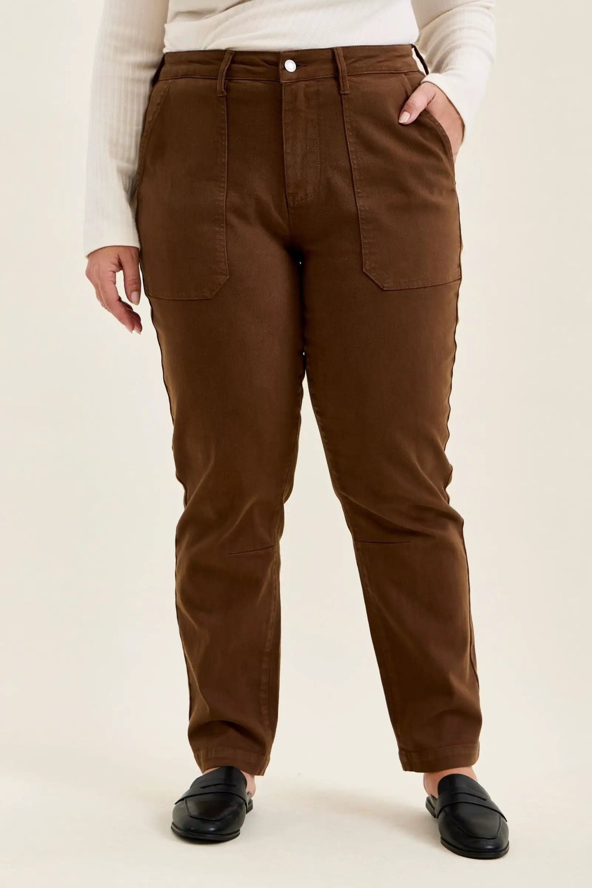 Mahogany high-waist plus size jeans featuring slim-straight legs, large utility pockets, and double-rolled cuffs paired with black loafers.
