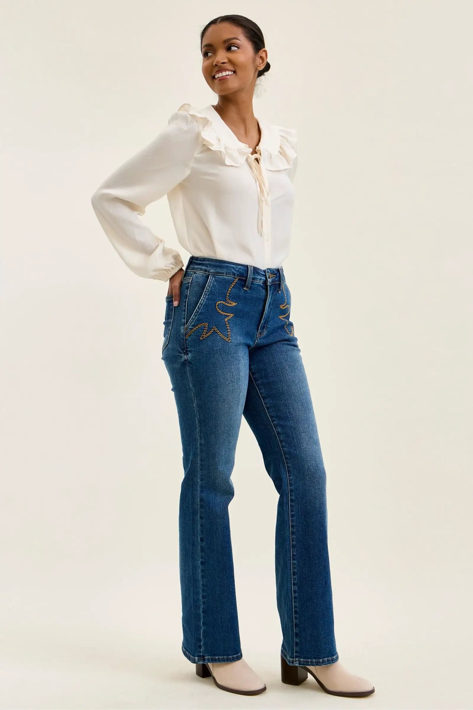 Jeans by Judy Blue Daisy mid-rise tummy-control bootcut in blue denim with gold western stitching