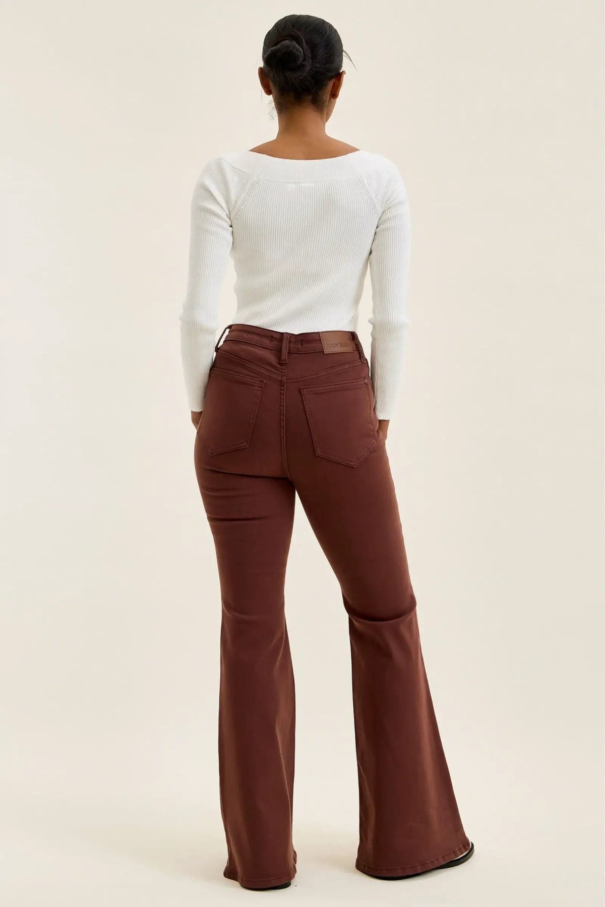 Judy Blue Jaqueline high-waist flare jeans in cocoa brown, back view with rear pockets and leather brand patch.