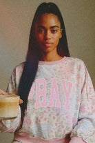 Graphic sweatshirt by Grateful Threads Boutique featuring pink floral granny-quilt print and large PRAY lettering