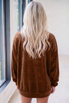 Back view of a woman with long blonde hair wearing a deep coffee velvet sweatshirt for a cozy Southern style.