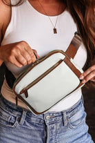 A woman is holding onto her purse