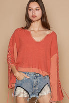 Here's an alt tag for the image: Coral lace-up sleeve waffle knit top.