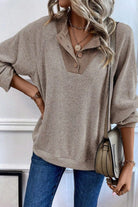 Beige ribbed knit sweater with buttons.