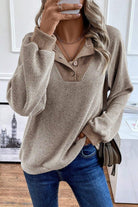 Beige ribbed knit button-up sweater.