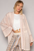 Pink eyelet kimono with bell sleeves.