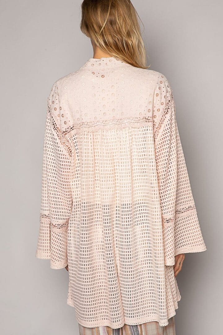 Here's an alt text option for the image: Pink embroidered eyelet tunic top.