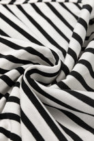 A close up of the fabric with black and white stripes