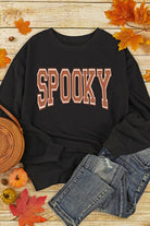 A black sweatshirt with the word spooky on it.