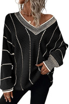 A woman wearing a black and white sweater.