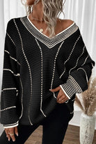 A woman wearing a black and white sweater.