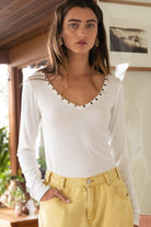 White studded long-sleeve top.