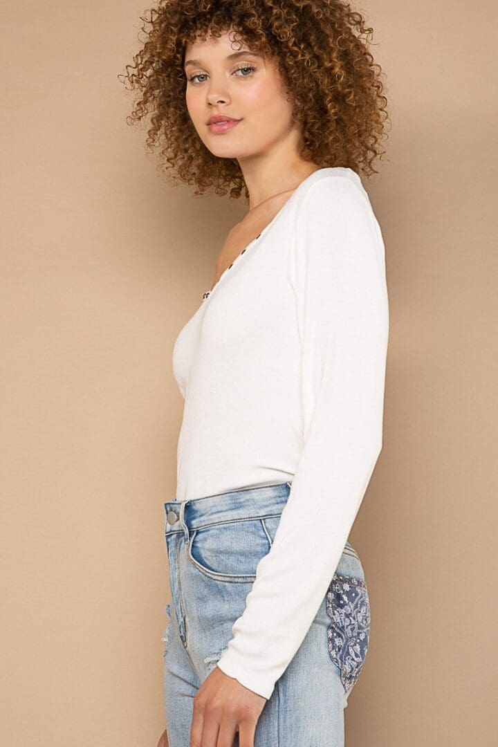 Woman in white top and jeans.