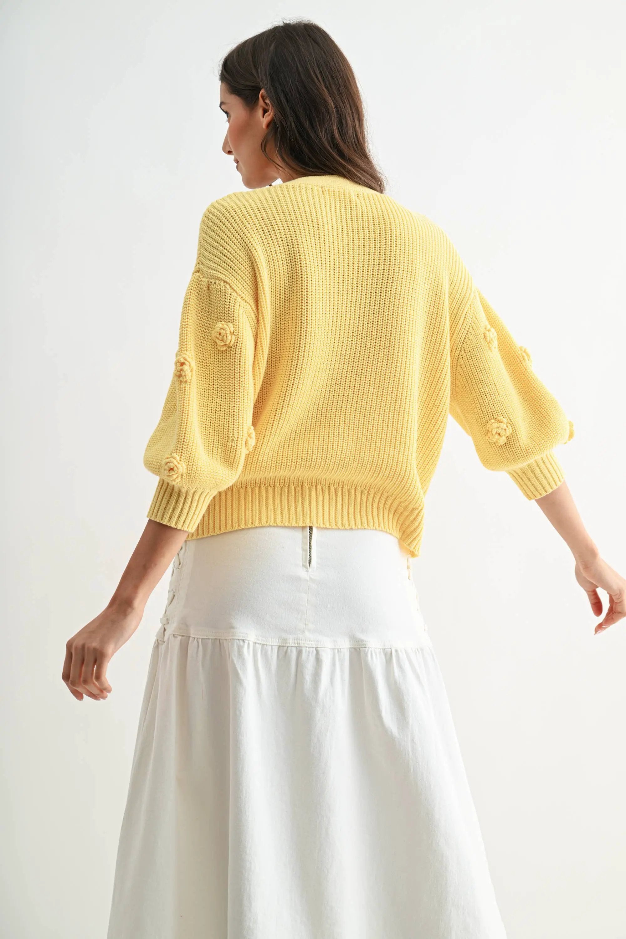 LT.YELLOW textured knit cardigan with 3D floral accents, back view.