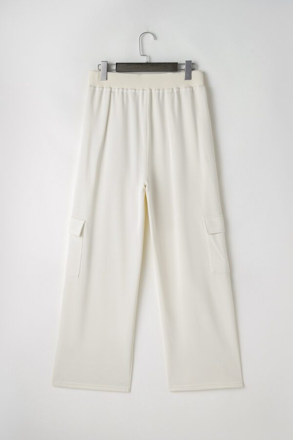 A pair of white pants with pockets on the side.