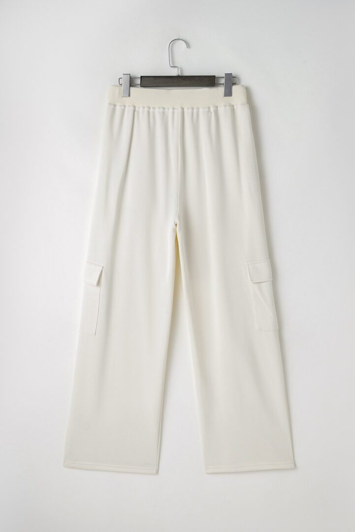 A pair of white pants with pockets on the side.