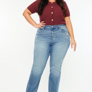 A woman standing in front of the camera wearing jeans.