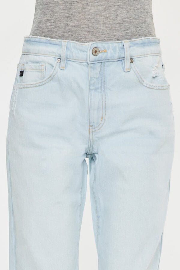 A pair of light blue jeans with a white logo on the back.