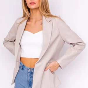 Beige blazer with denim shorts.