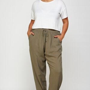 Woman in white top and olive pants.